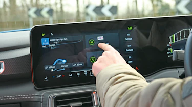 Auto Express senior content editor Shane Wilkinson operating the Ford Mustang's infotainment system