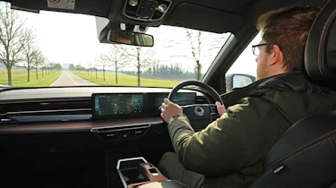 KGM Torres EVX - driving shot with Online reviews editor, Max Adams
