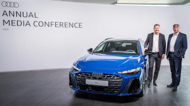 Audi executives standing next to an Audi A6 Avant
