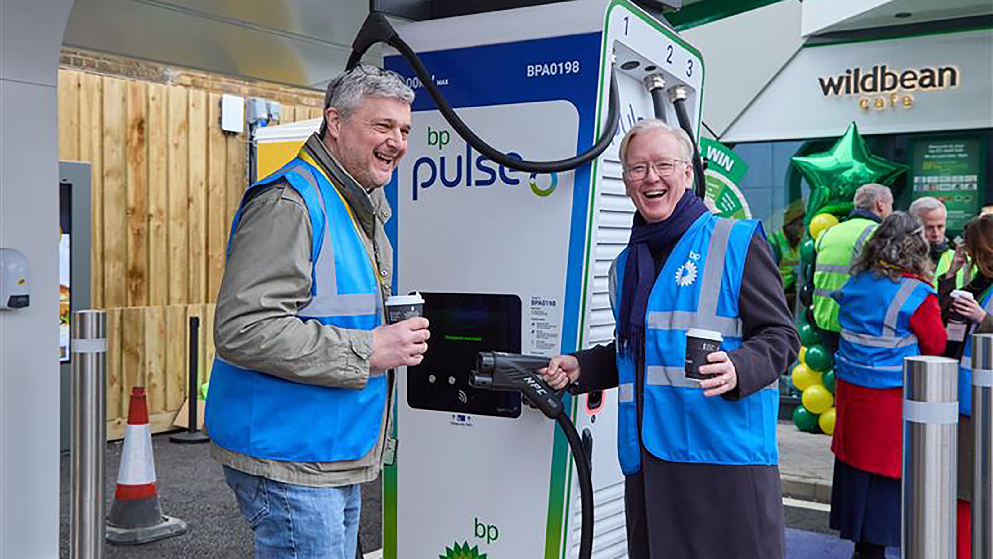 Chris Rosamond and Richard Bartlett standing next to a BP Pulse charger
