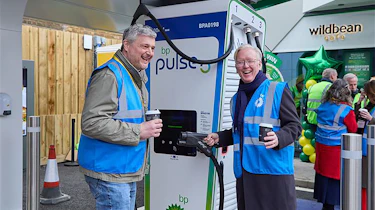 Chris Rosamond and Richard Bartlett standing next to a BP Pulse charger