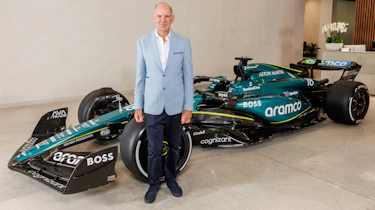 Adrian Newey standing in front of an Aston Martin F1 car
