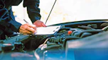Mechanic inspecting a car's engine bay