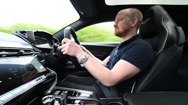 Auto Express chief reviewer Alex Ingram driving the Aston Martin Vanquish