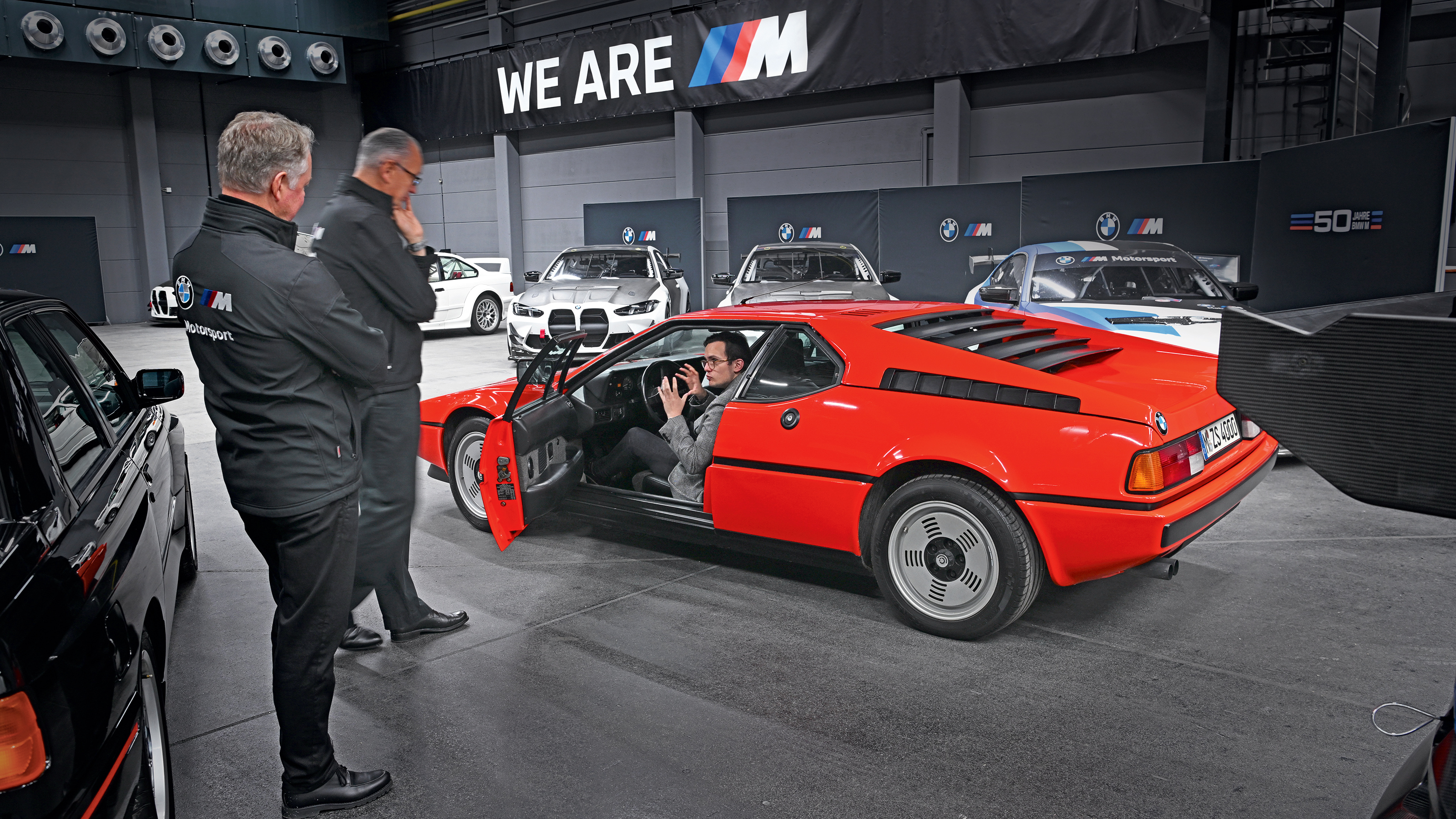 Auto Express consumer reporter Tom Jervis sitting in a BMW M1
