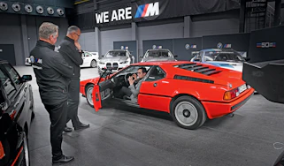 Auto Express consumer reporter Tom Jervis sitting in a BMW M1