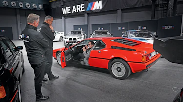 Auto Express consumer reporter Tom Jervis sitting in a BMW M1