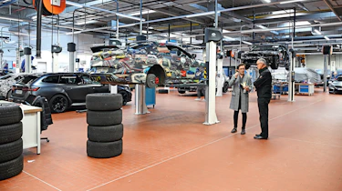 Auto Express consumer reporter Tom Jervis standing in a BMW M division workshop
