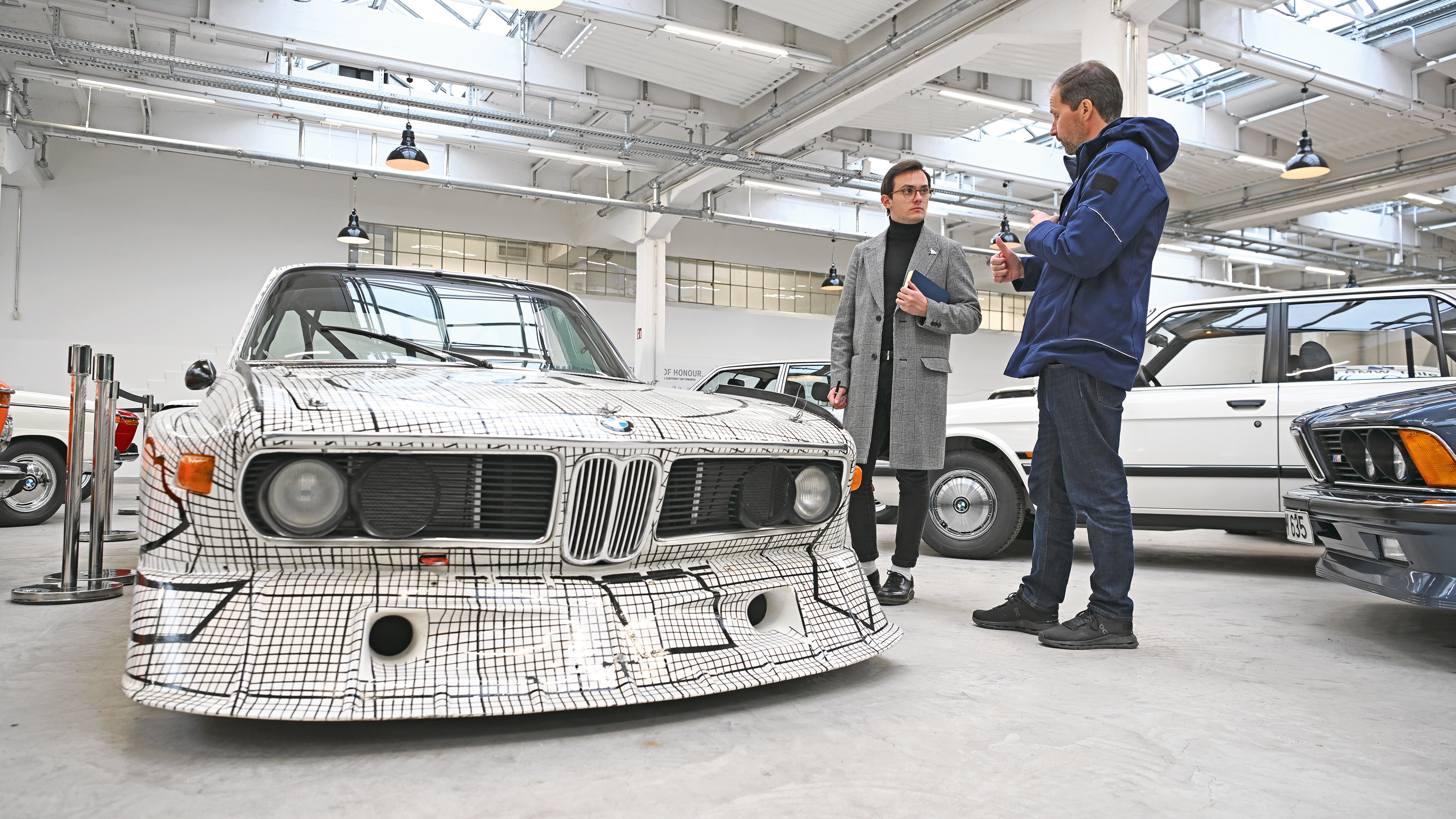 Auto Express consumer reporter Tom Jervis standing next to a BMW 3.0 CSL