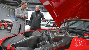Auto Express consumer reporter Tom Jervis inspecting a BMW M1's engine bay