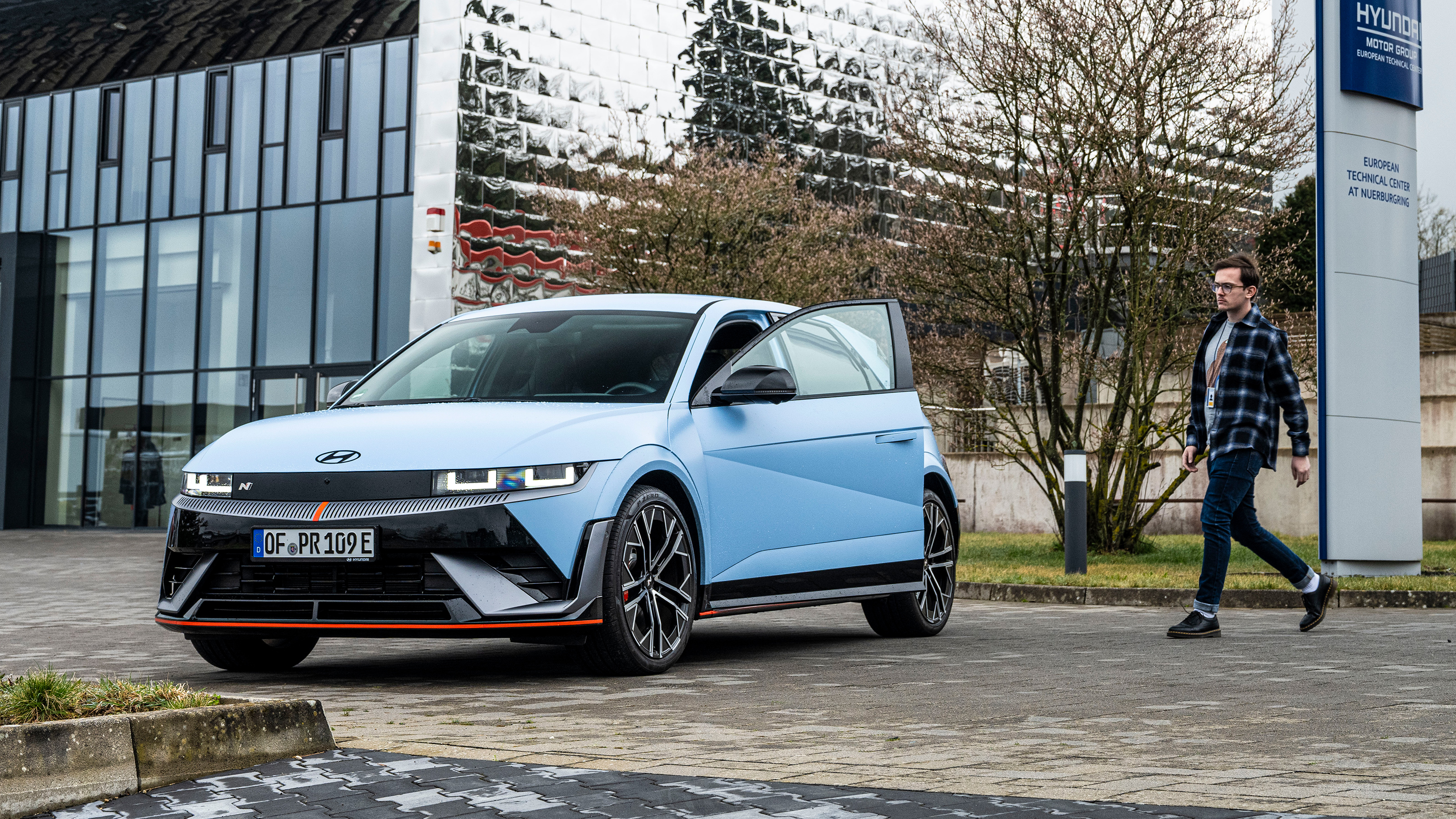 Auto Express consumer reporter Tom Jervis standing in walking towards a Hyundai Ioniq 5 N