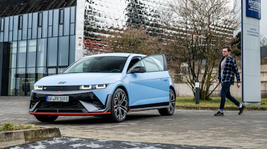Auto Express consumer reporter Tom Jervis standing in walking towards a Hyundai Ioniq 5 N
