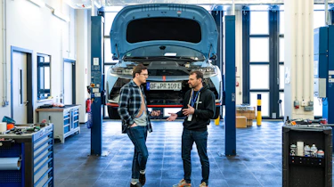 Auto Express consumer reporter Tom Jervis standing in front of a Hyundai Ioniq 5 N on a workshop ramp