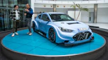 Auto Express consumer reporter Tom Jervis standing next to a Hyundai N racing car