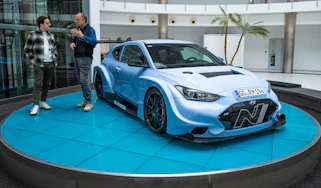 Auto Express consumer reporter Tom Jervis standing next to a Hyundai N racing car
