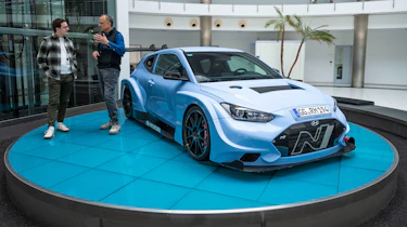 Auto Express consumer reporter Tom Jervis standing next to a Hyundai N racing car