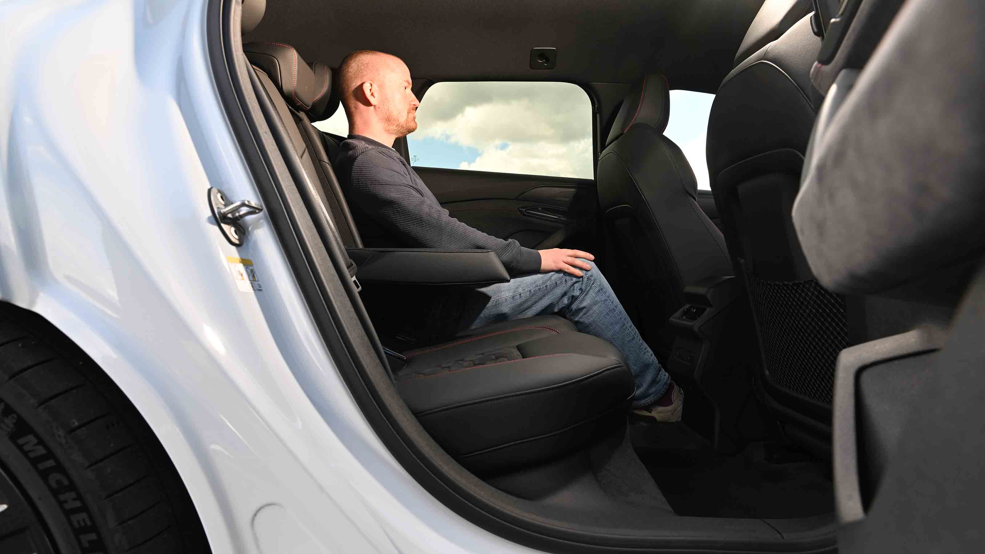 Audi S6 Avant e-tron - rear seats with Auto Express Chief reviewer, Alex Ingram