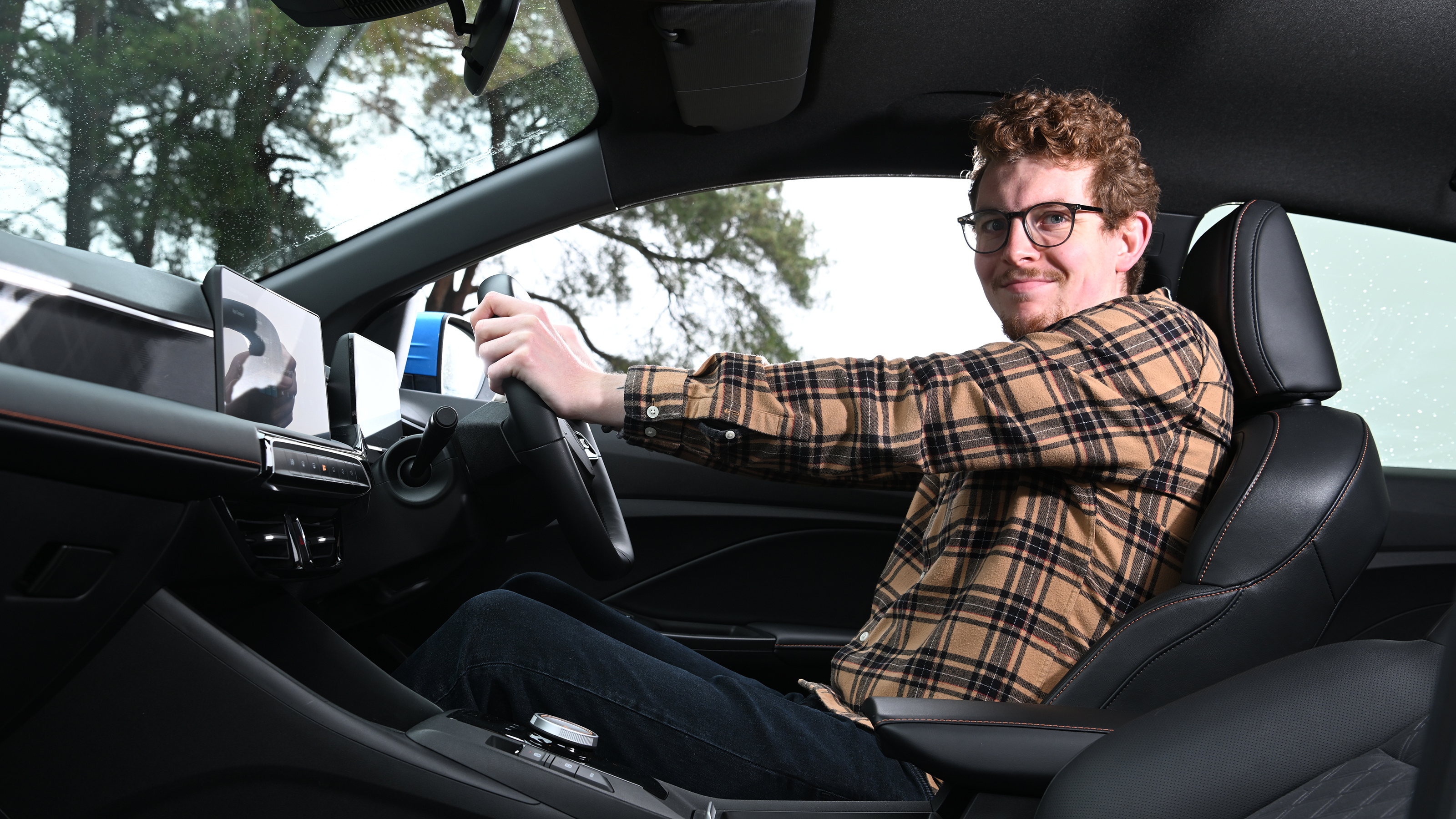 Auto Express content editor Ryan Birch sitting in the MG3