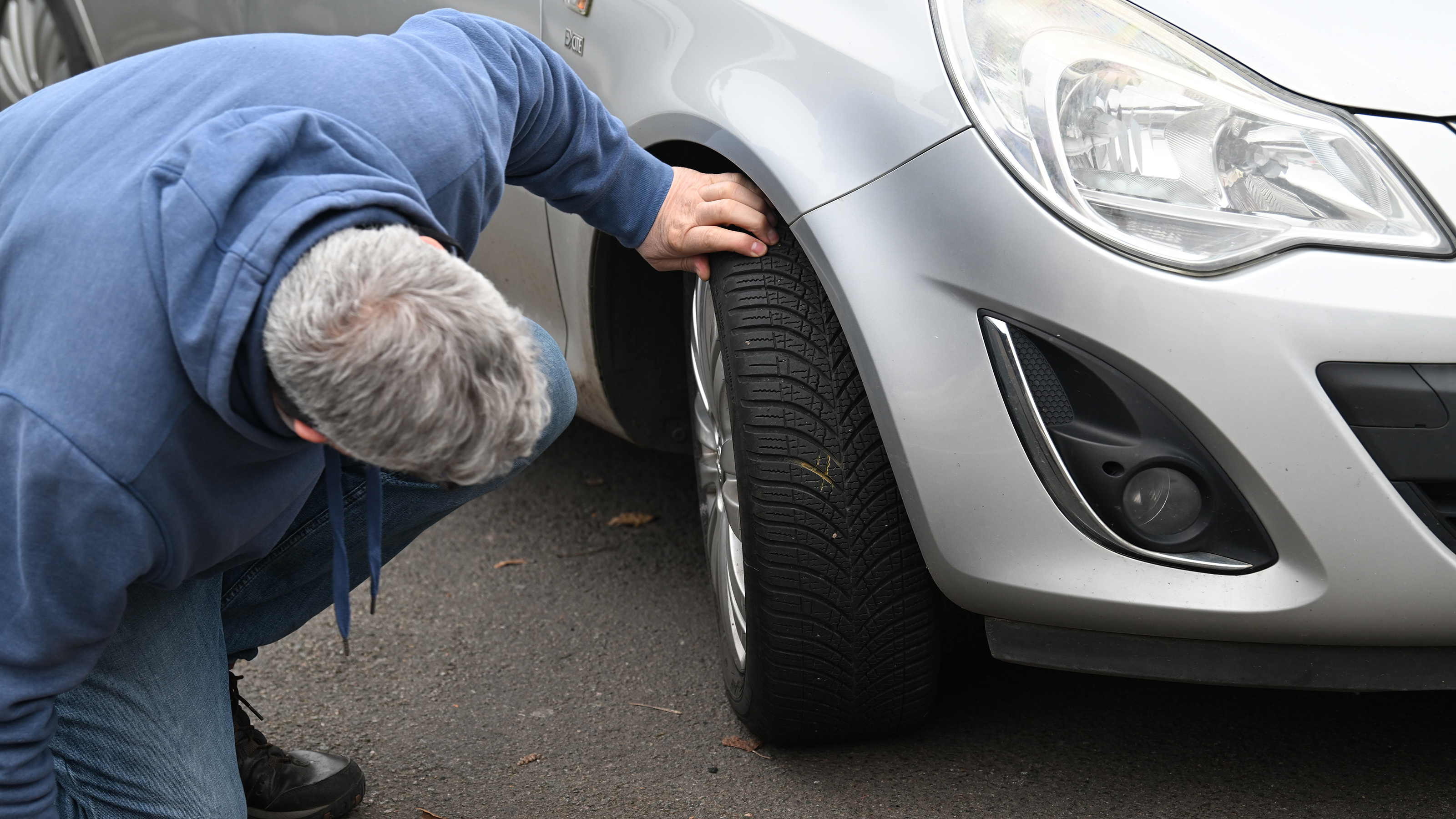 Auto Express consumer editor Chris Rosamond inspecting a Vauxhall Corsa's tyre