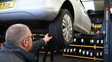Protyre area manager Simon Hall inspecting a Vauxhall Corsa's tyre