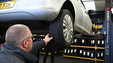 Protyre area manager Simon Hall inspecting a Vauxhall Corsa's tyre