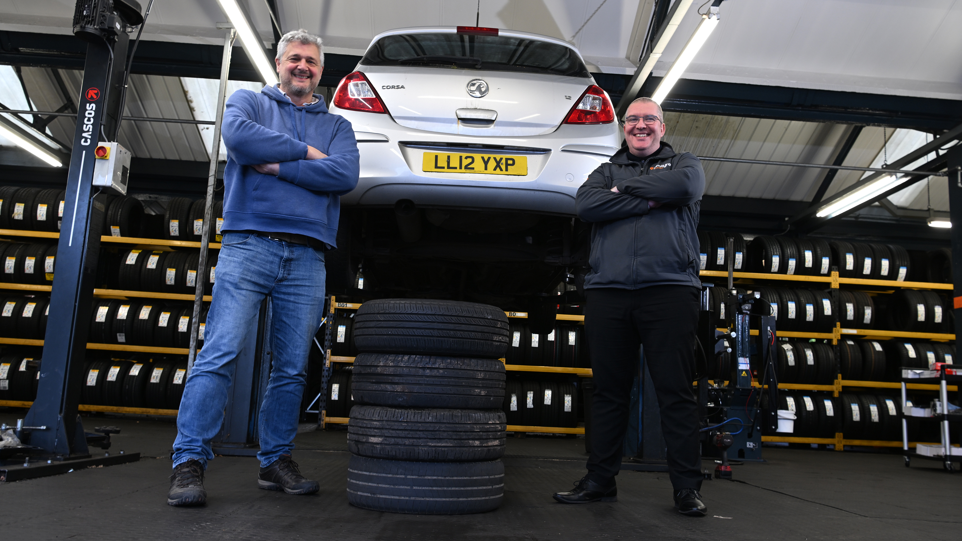 Auto Express consumer editor Chris Rosamond and Protyre area manager Simon Hall standing next to a vehicle inspection ramp