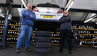 Auto Express consumer editor Chris Rosamond and Protyre area manager Simon Hall standing next to a vehicle inspection ramp