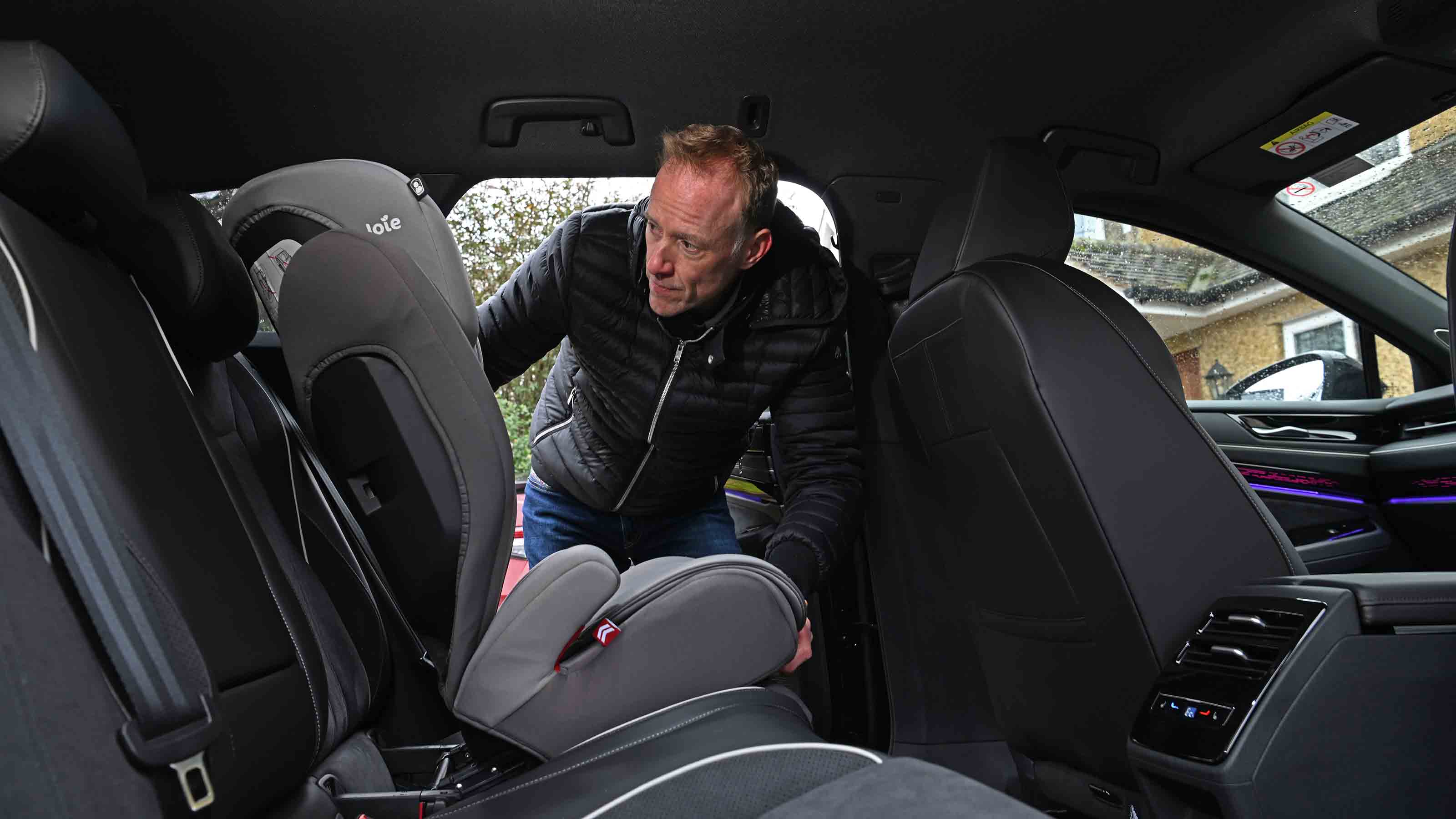 Volkswagen ID.7 Tourer - rear seats with Auto Express’ editor-at-large, Phil McNamara installing a child seat