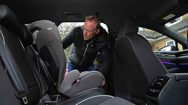 Volkswagen ID.7 Tourer - rear seats with Auto Express’ editor-at-large, Phil McNamara installing a child seat