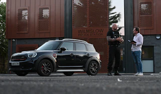 Auto Express consumer reporter Tom Jervis talking to PC Mark Jones outside Wilmslow police station