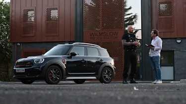 Auto Express consumer reporter Tom Jervis talking to PC Mark Jones outside Wilmslow police station