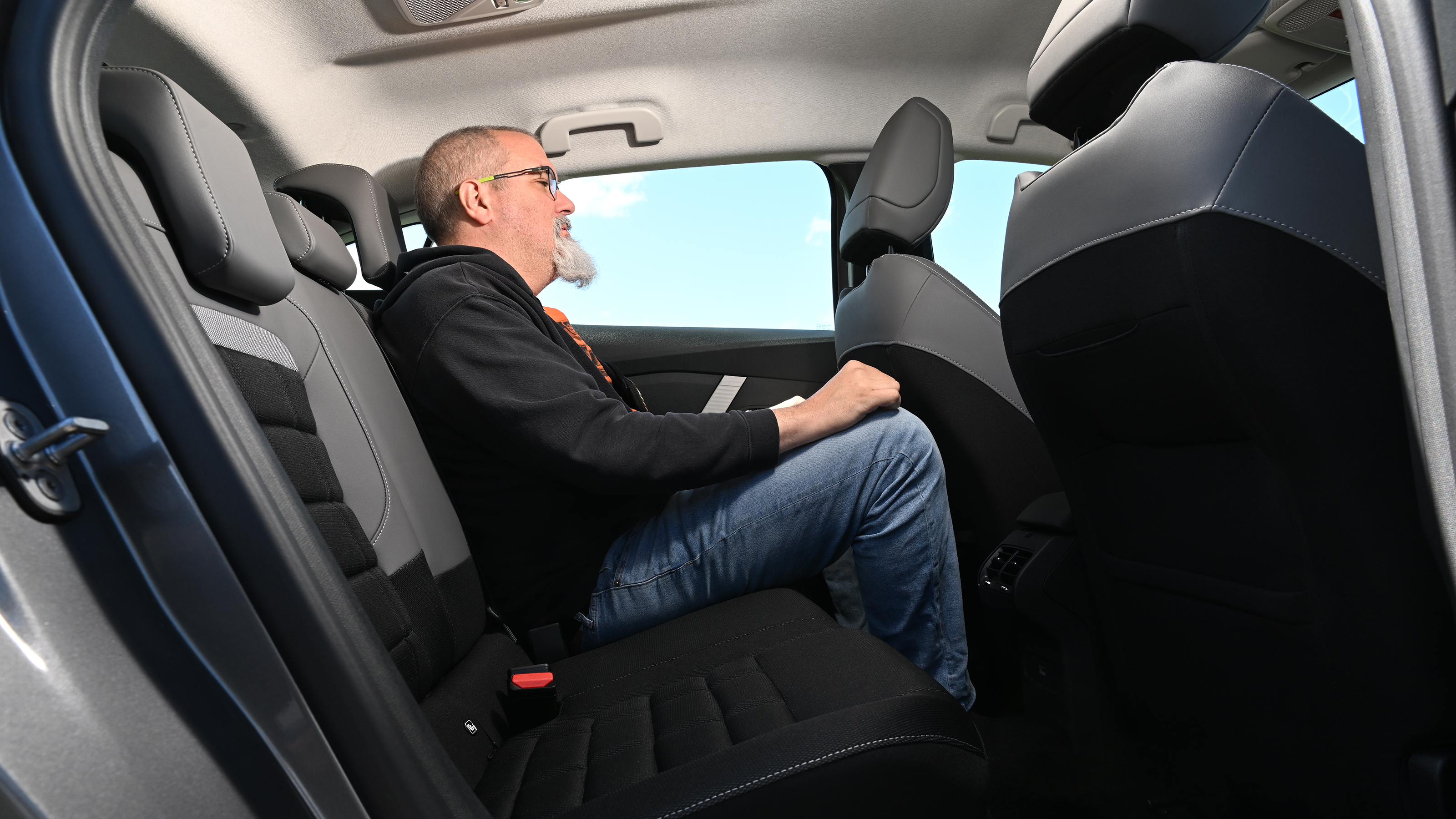 Citroen e-C4 - rear seats being sat in by Auto Express senior test editor, Dean Gibson