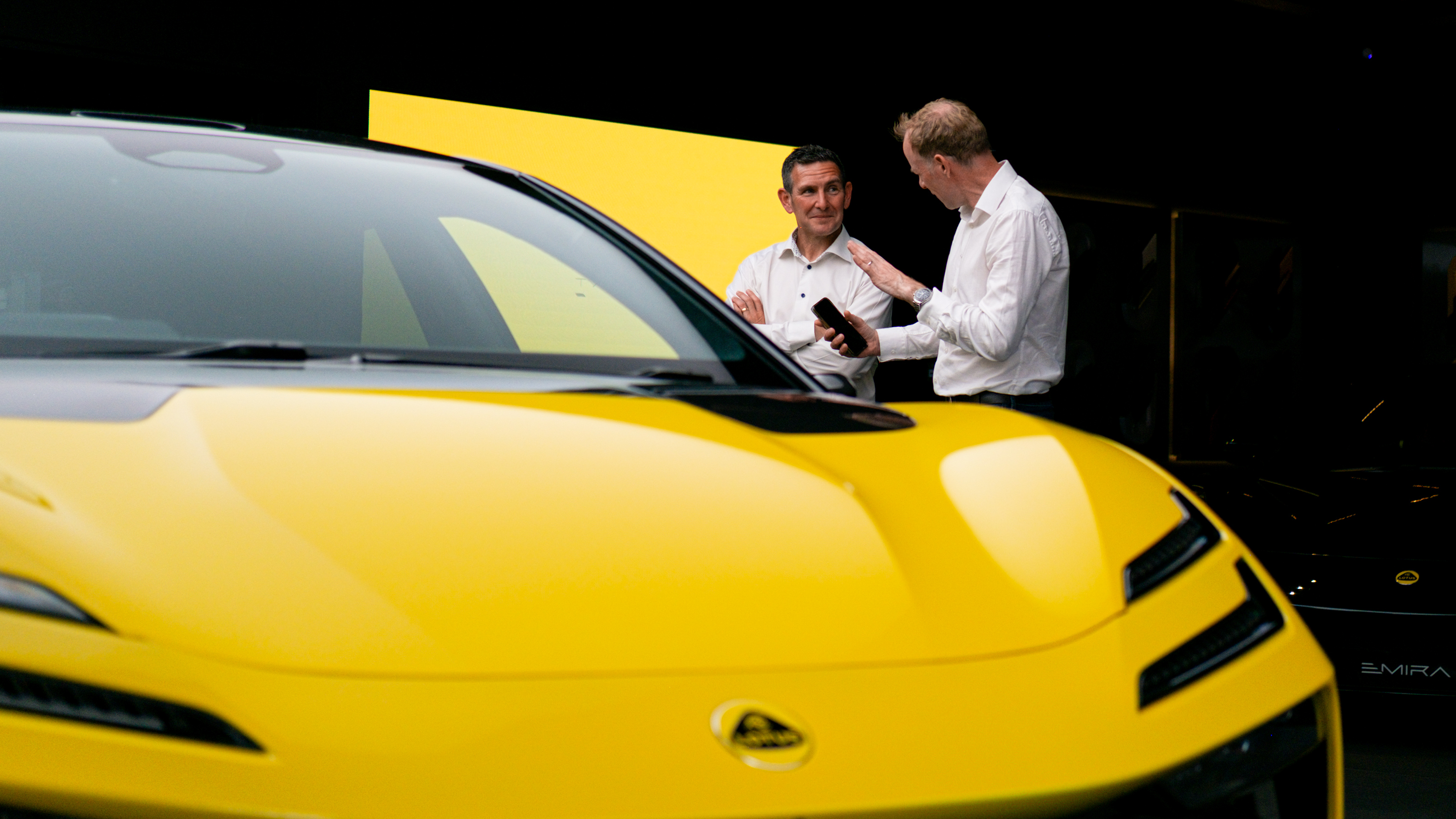 Auto Express editor-at-large Phil McNamara standing next to a Lotus Emeyal