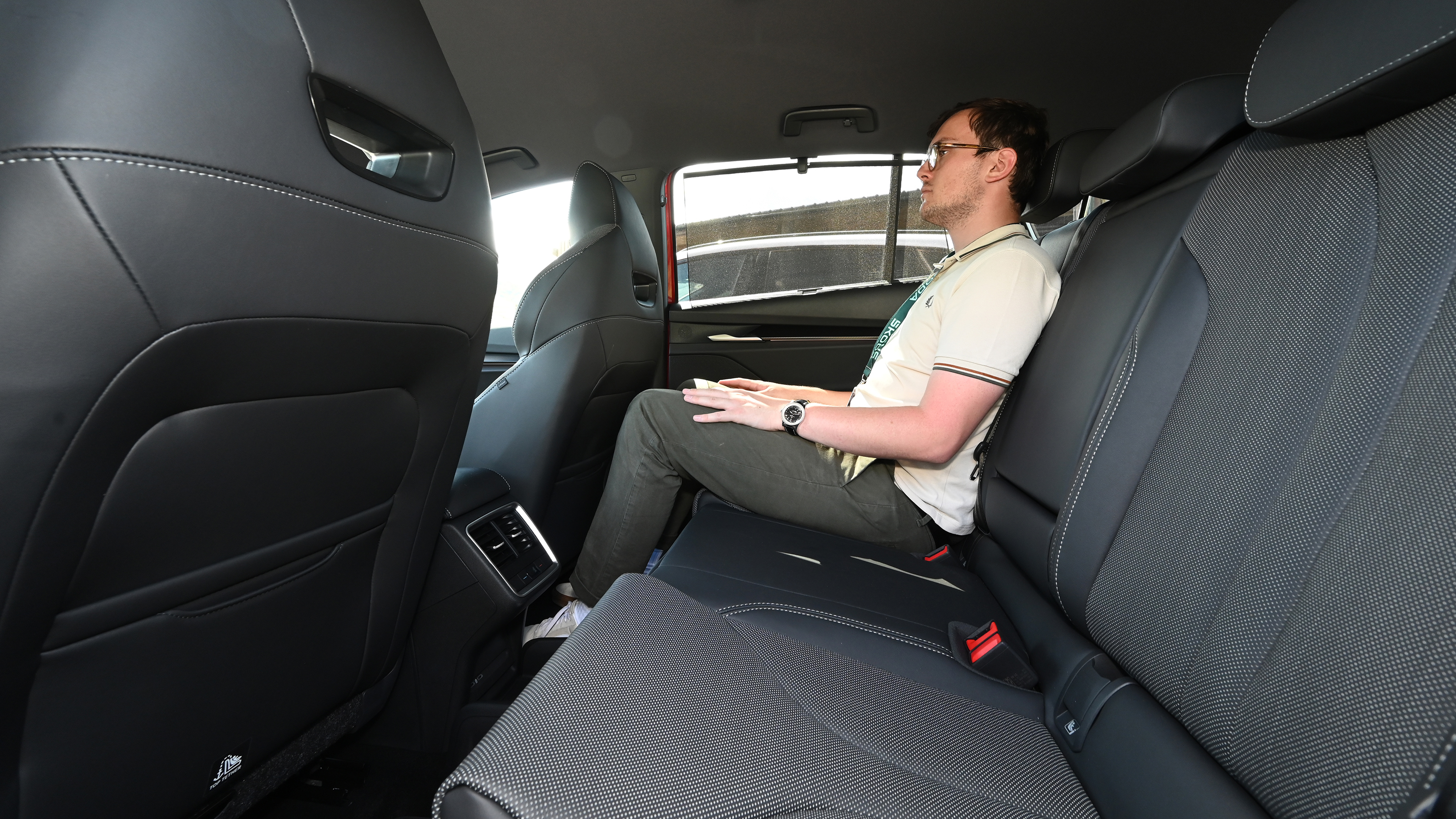 Auto Express consumer reporter Tom Jervis sitting in the Skoda Enyaq vRS's rear seat