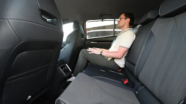 Auto Express consumer reporter Tom Jervis sitting in the Skoda Enyaq vRS's rear seat