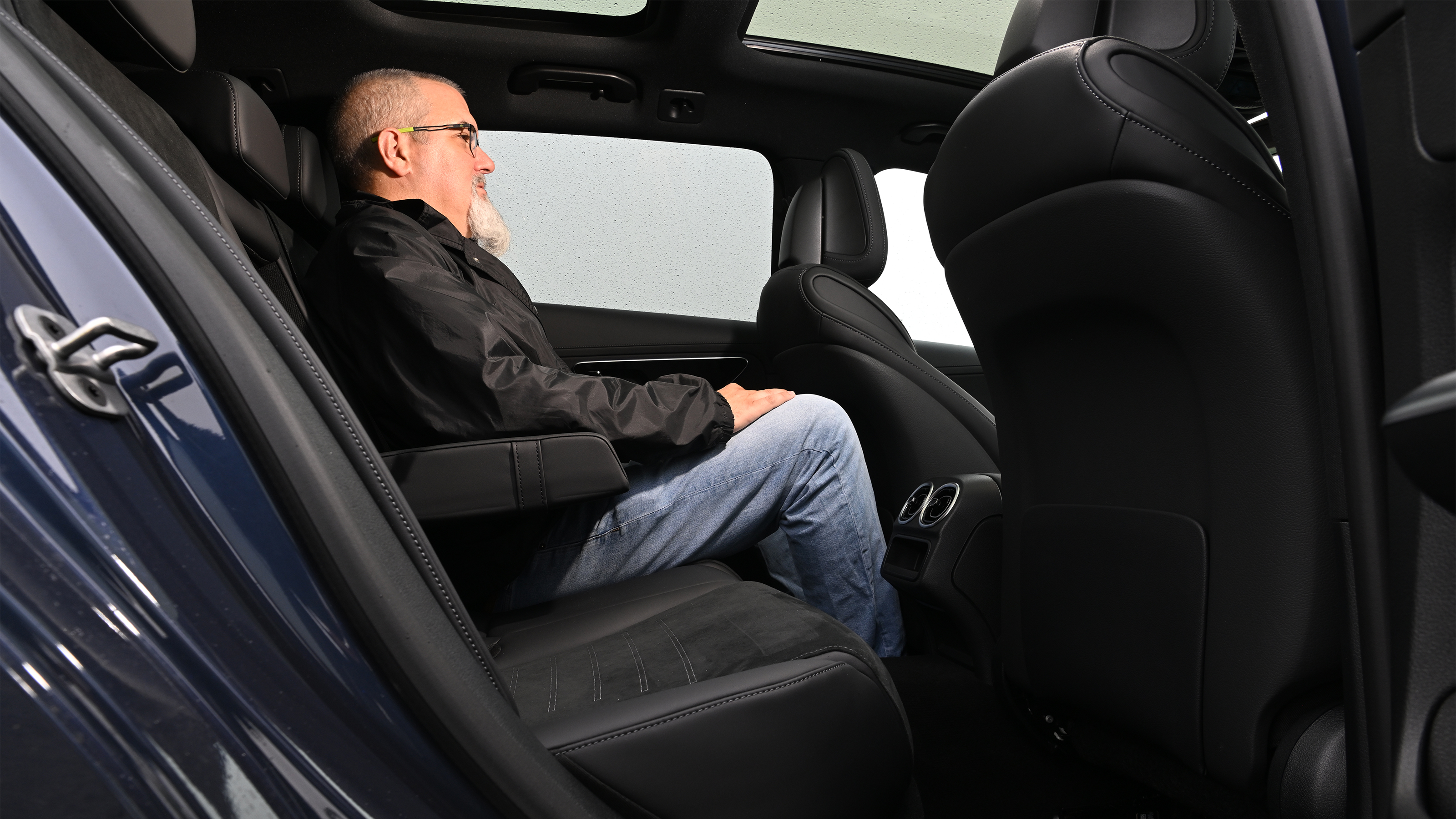 Auto Express senior test editor Dean Gibson sitting in the Mercedes C 300 estate's rear seat