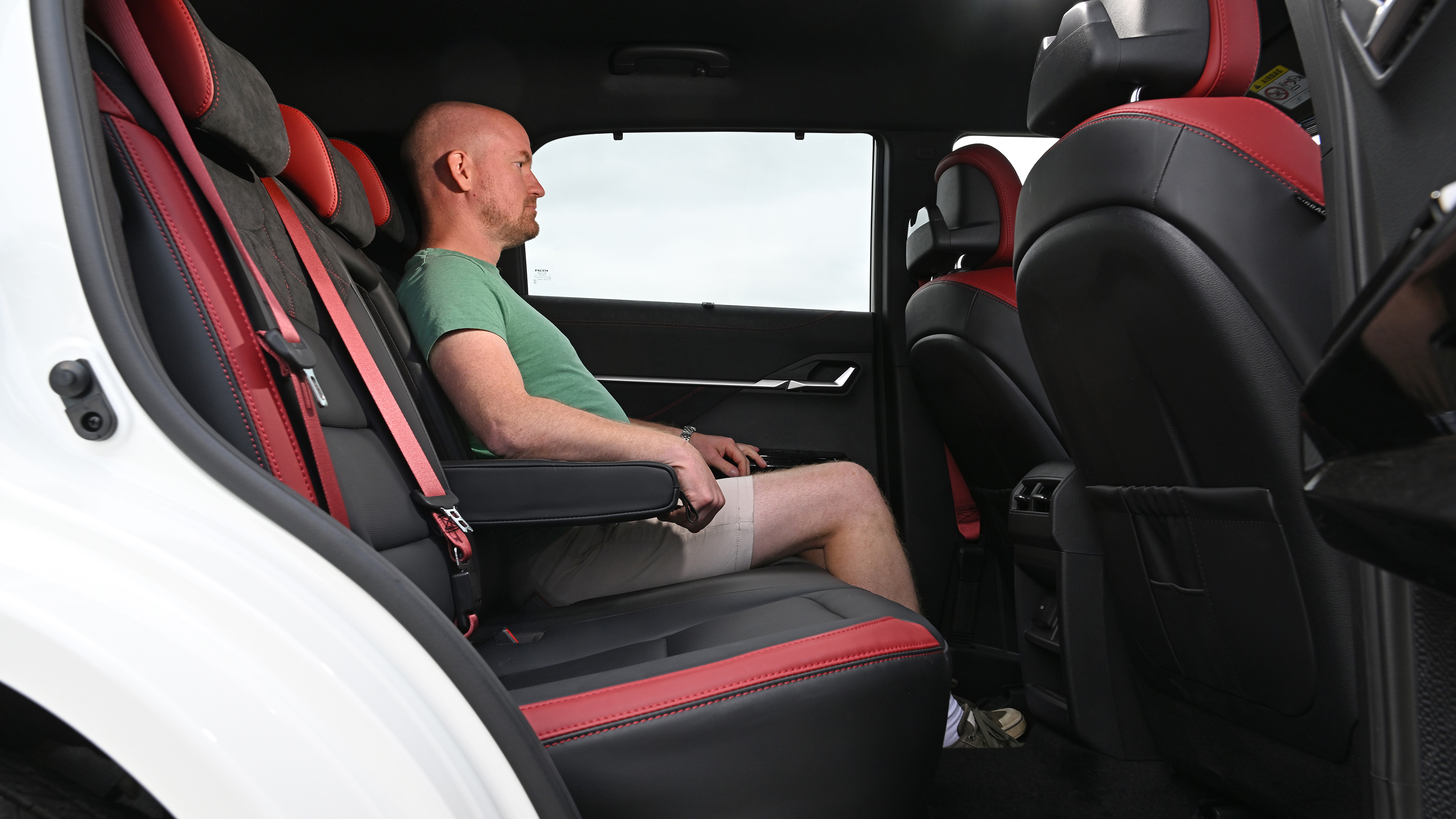 Auto Express chief reviewer sitting in the KGM Actyon's rear seat