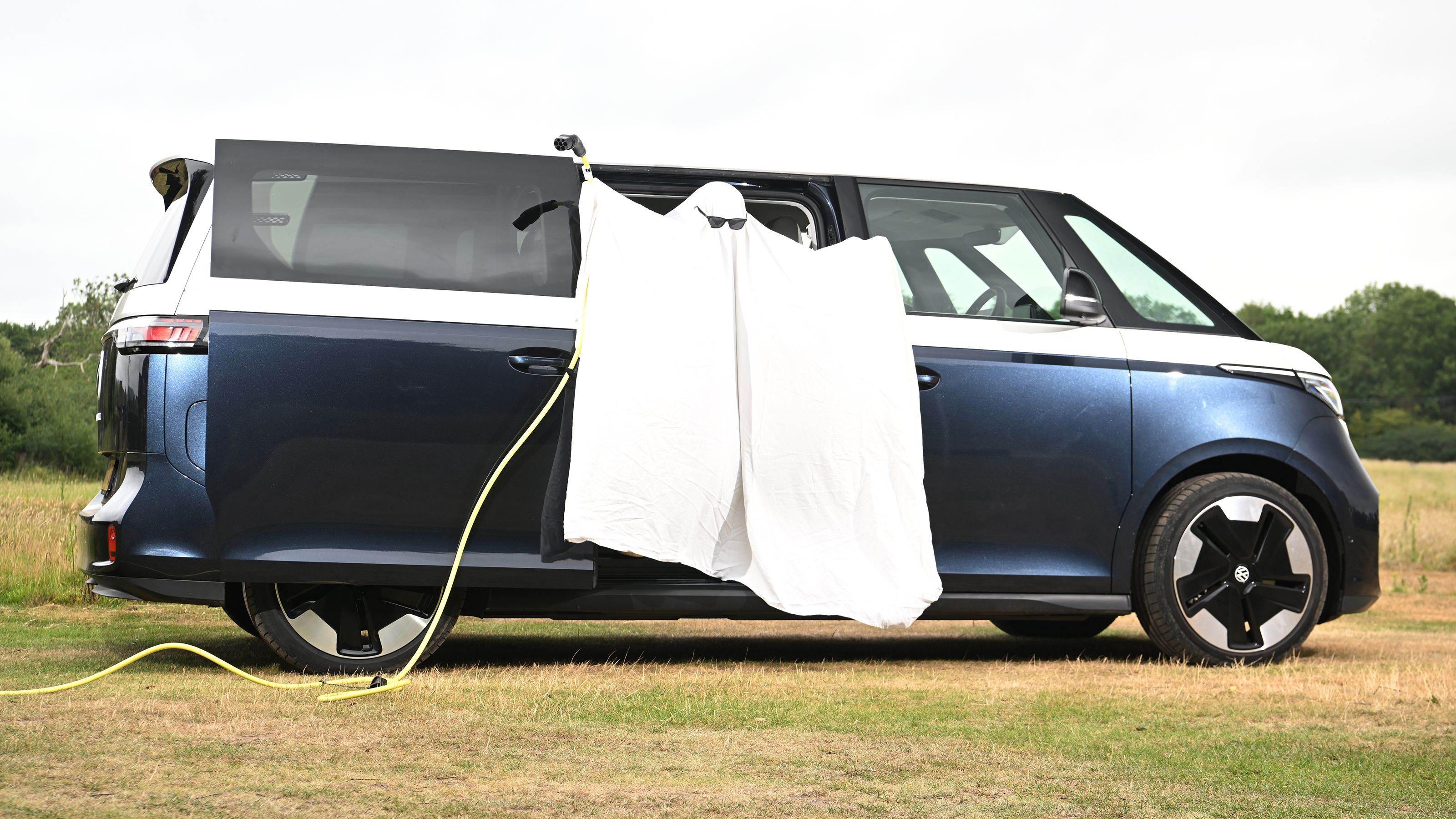 Auto Express head of digital content Steve Walker dressed as a ghost while standing in the Volkswagen ID. Buzz LWB