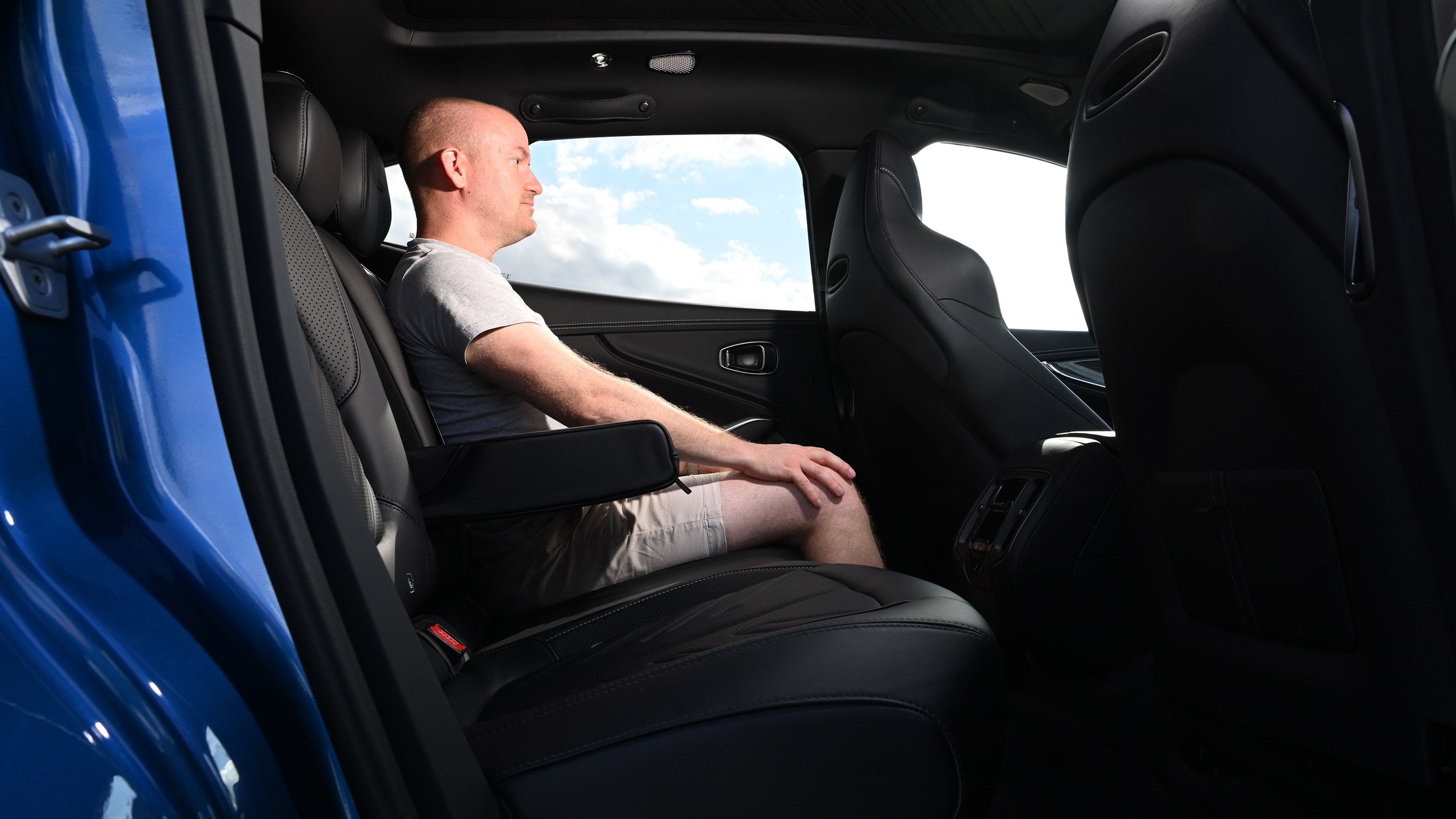 Auto Express contributor Alex Ingram sitting in the Aston Martin DBX S's rear seat