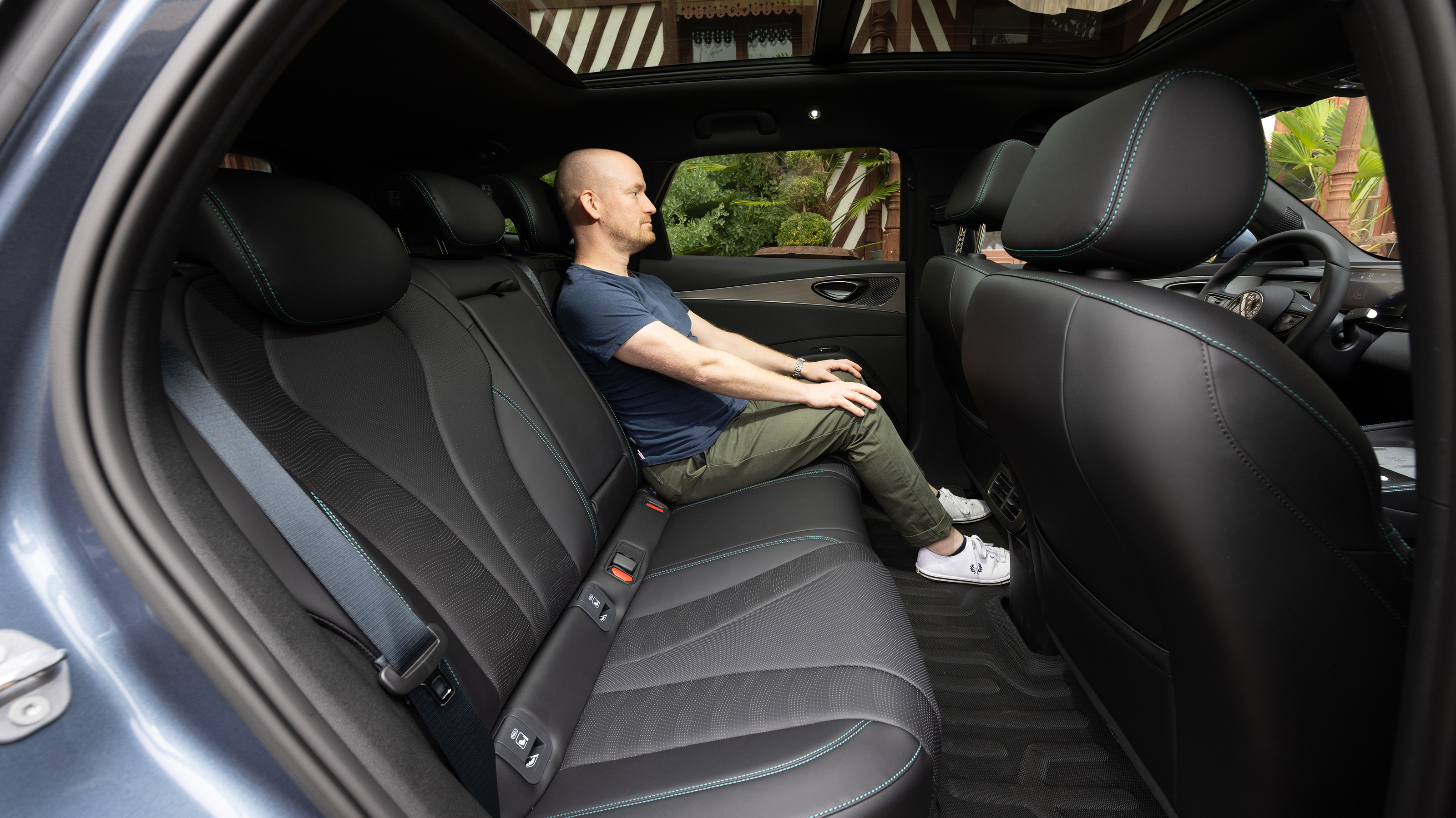 Auto Express chief reviewer Alex Ingram sitting in the BYD Seal 6 Touring's back seat