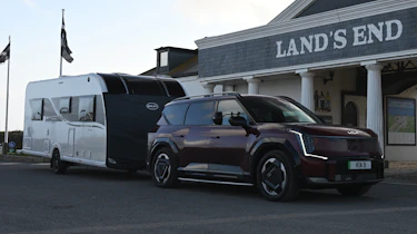 EV tow test - Kia and caravan in front of Lands End hotel