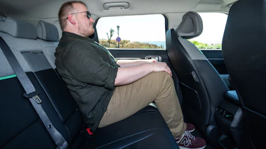 Ellis Hyde sitting in the Kia EV4