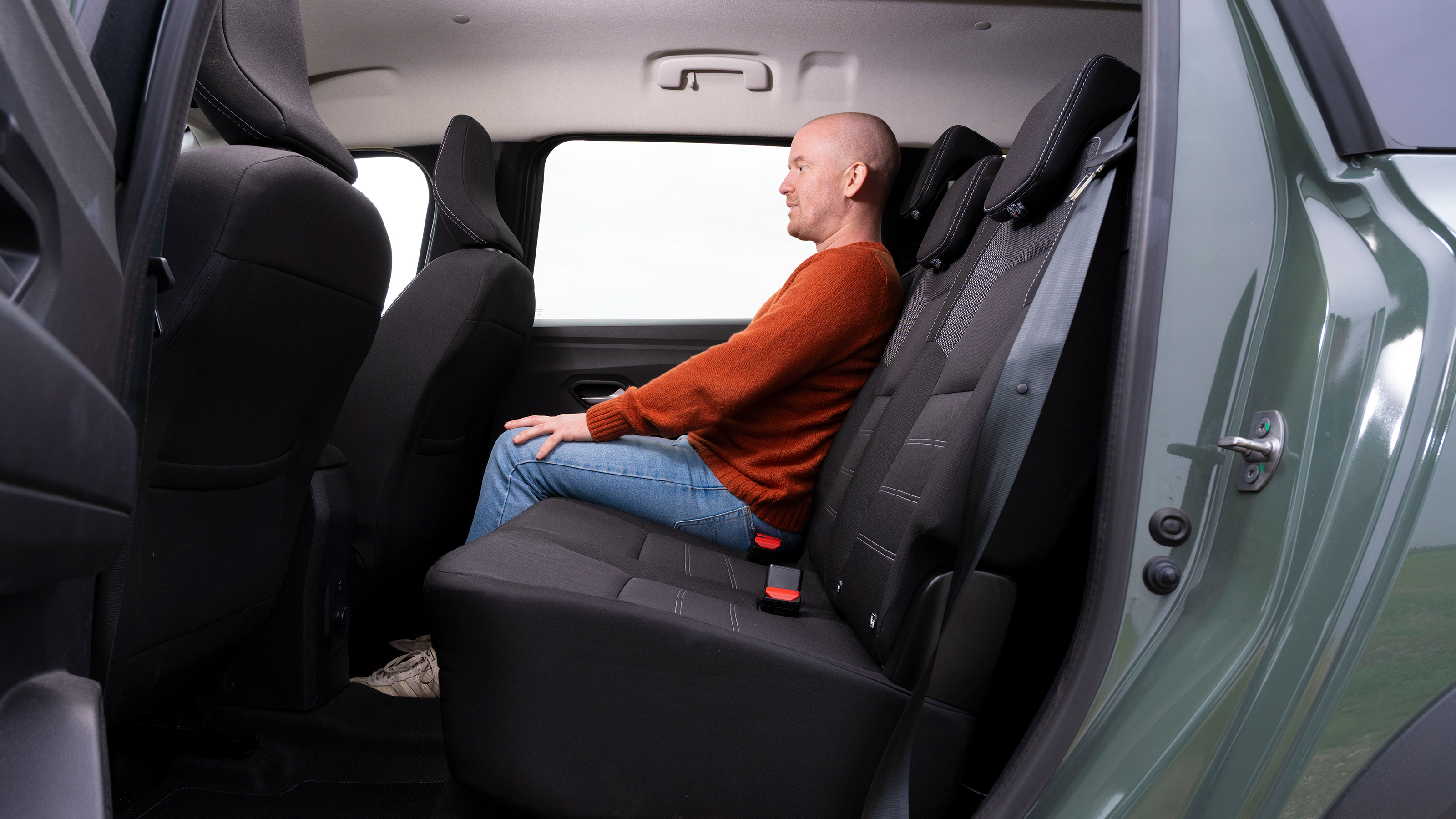 Former Auto Express chief reviewer Alex Ingram sitting in the Dacia Jogger's middle row seat