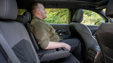 Auto Express news reporter Ellis Hyde sitting in the Jeep Compass's back seat