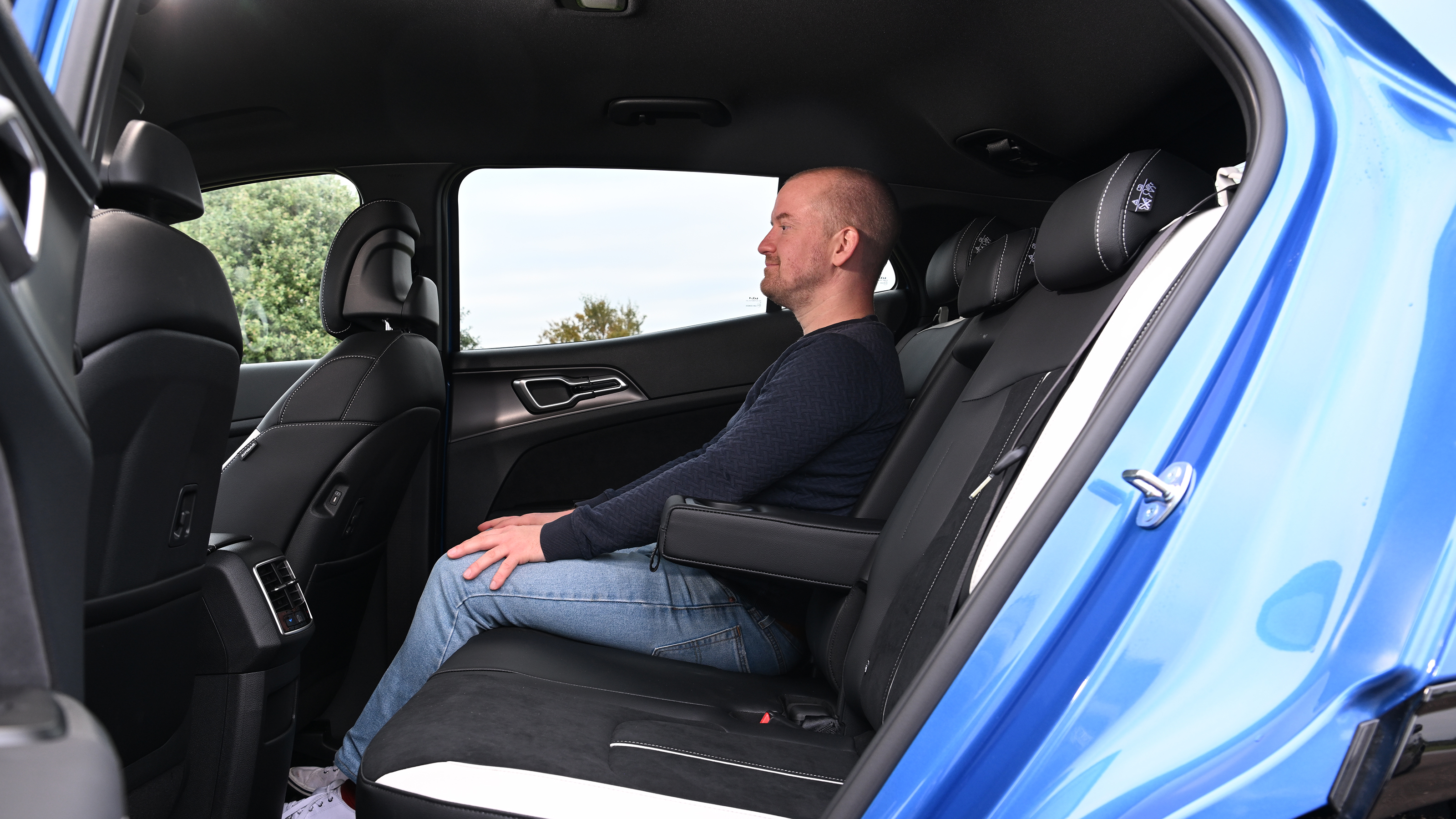 Kia Sportage - rear seats, car being sat in by Auto Express chief reviewer Alex Ingram 