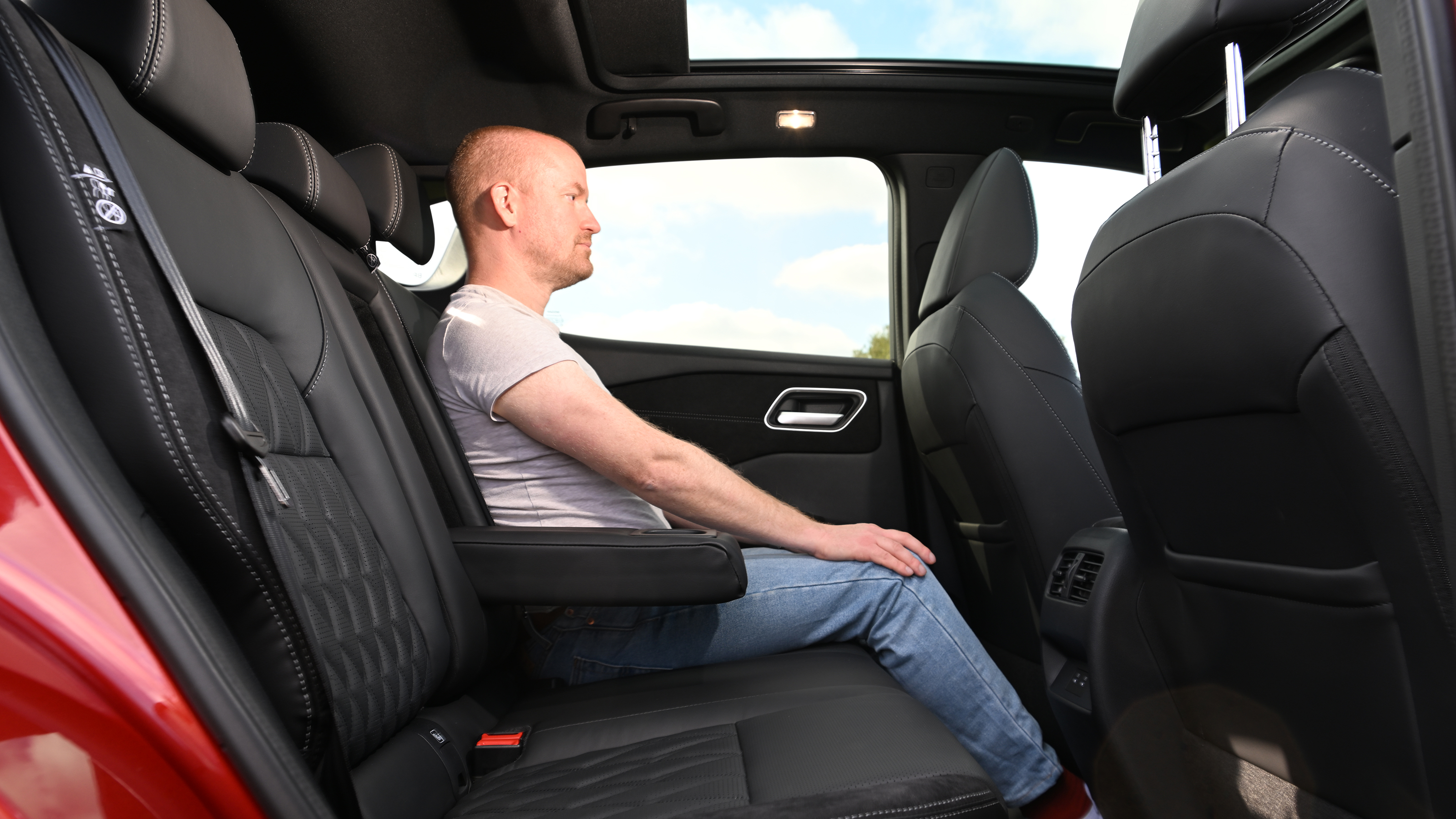 Nissan Qashqai - rear seats being sat in by Auto Express chief reviewer Alex Ingram 