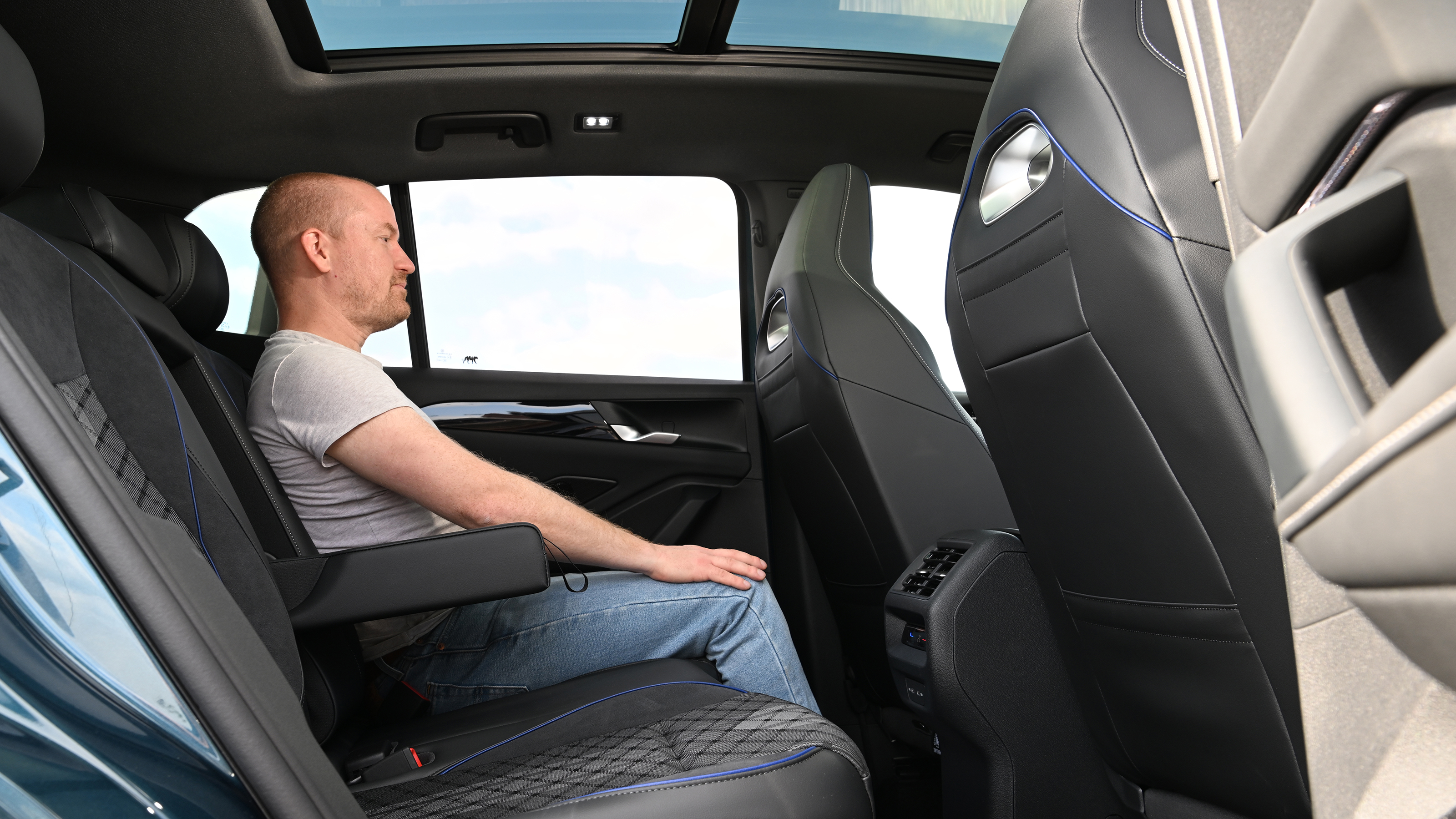 Volkswagen Tiguan - rear seats being sat in by Auto Express chief reviewer Alex Ingram 