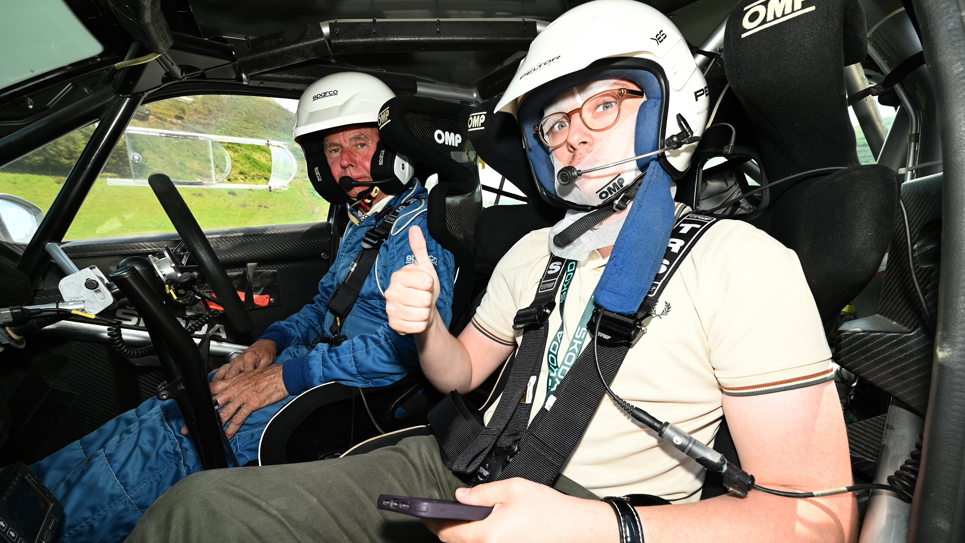 Auto Express consumer reporter Tom Jervis sitting in a Skoda Fabia rally car