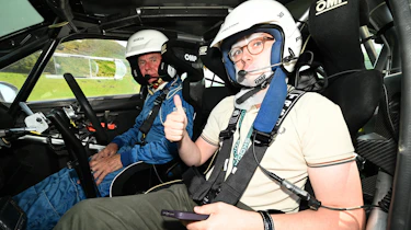 Auto Express consumer reporter Tom Jervis sitting in a Skoda Fabia rally car