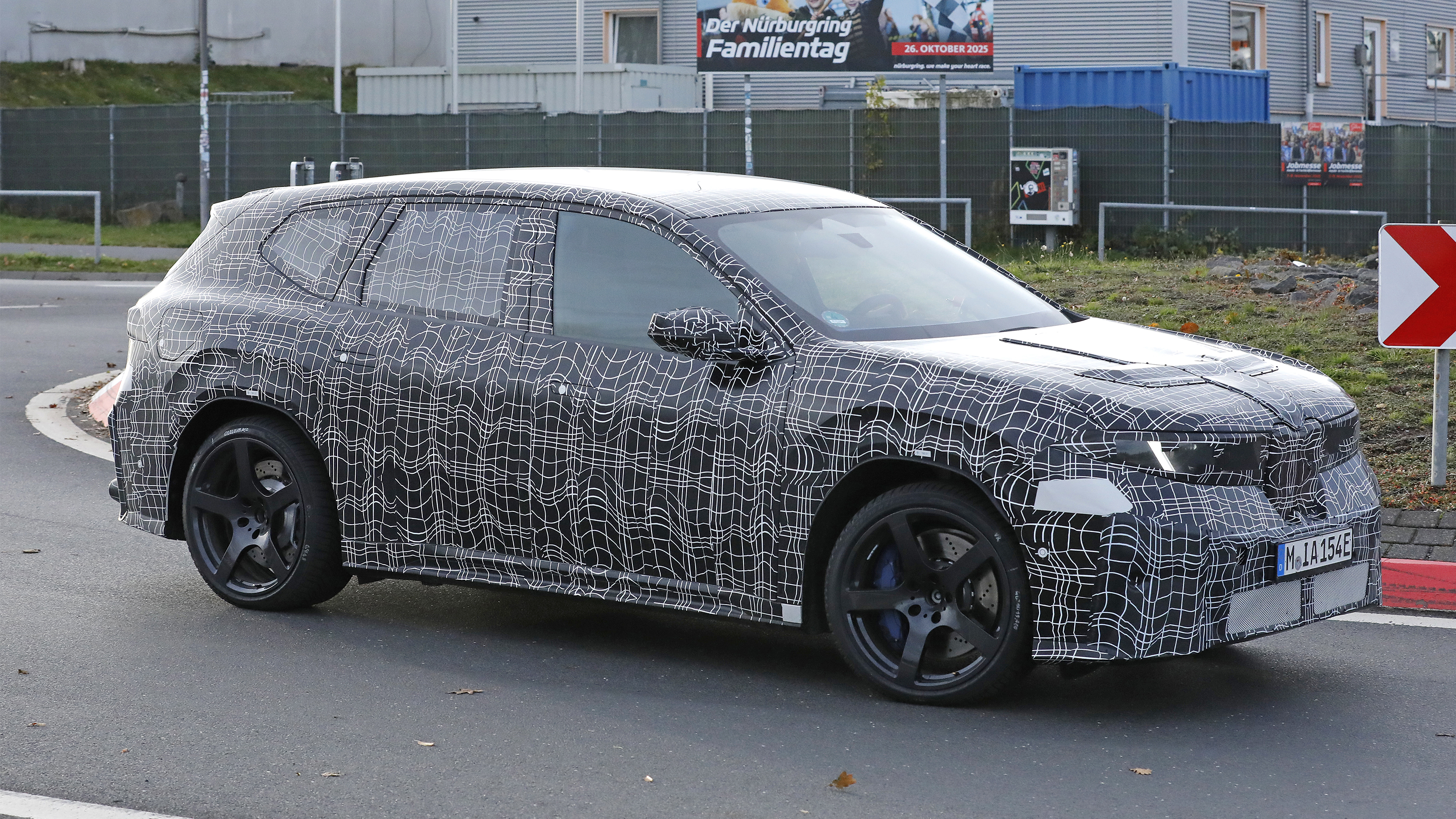 BMW iX3 M - front angled on a round-about